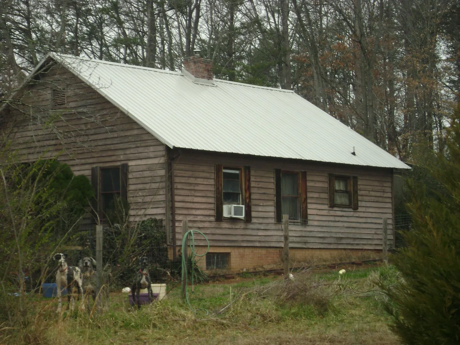 White metal roof on an old wood sided farmhouse, from a Metal Roof Installation job in Coker